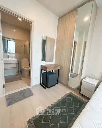 Modern bedroom with ensuite bathroom, featuring sleek design and ample natural light.