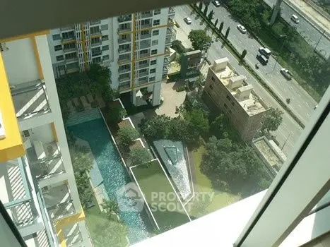 Stunning aerial view of modern residential complex with pool and lush greenery.