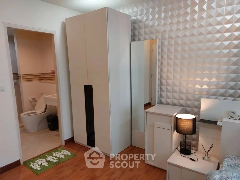 Modern bedroom with stylish geometric wall and sleek furniture
