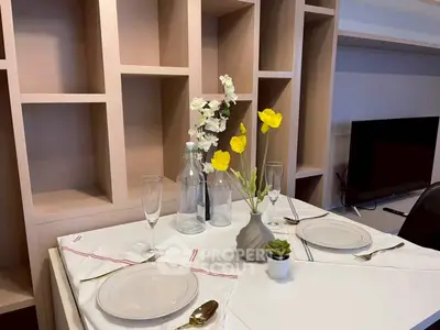 Elegant dining setup with modern shelving and TV in stylish living room