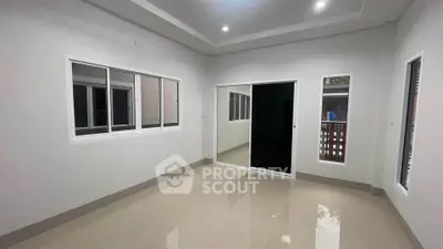 Spacious empty room with large windows and glossy tiled floor, perfect for customization.