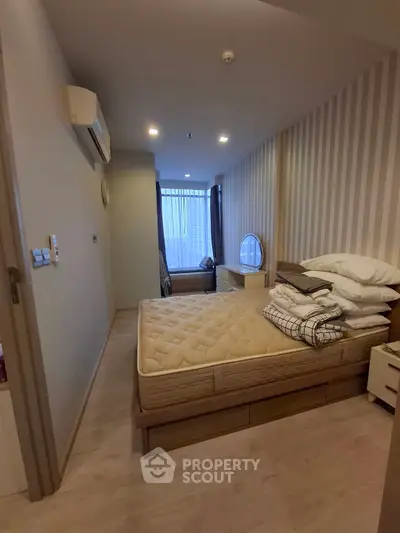 Cozy bedroom with modern decor and ample natural light, featuring a comfortable bed and stylish furnishings.
