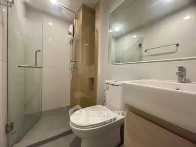 Modern bathroom with glass shower and sleek fixtures