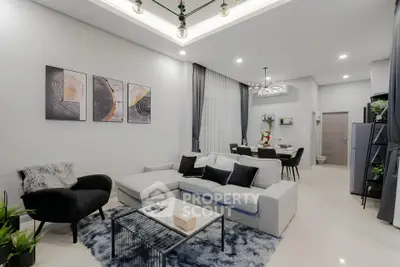 Modern living room with stylish decor and open layout, featuring a cozy seating area and elegant lighting.