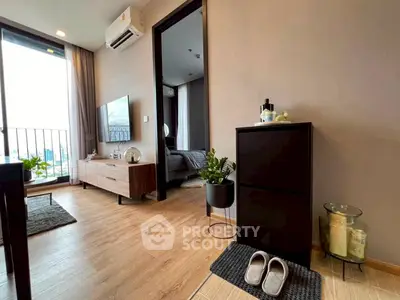 Modern apartment interior with stylish living room and bedroom, featuring wooden flooring and balcony view.