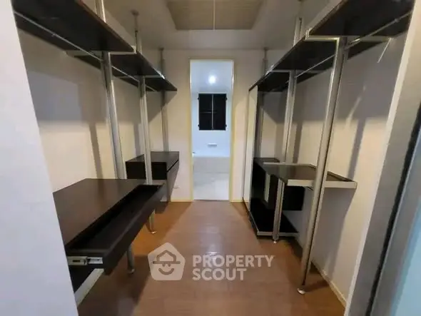 Spacious walk-in closet with modern shelving and ample storage space.