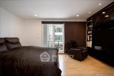 Luxurious bedroom with modern decor and large window offering natural light.