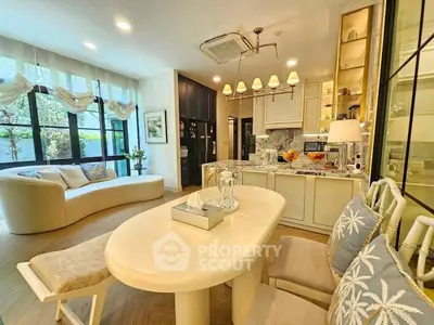 Luxurious open-layout living room with elegant kitchen and cozy seating area.