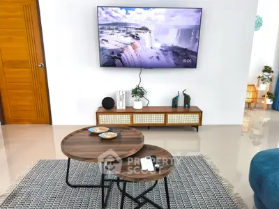 Modern living room with stylish furniture and wall-mounted TV, showcasing a cozy and inviting atmosphere.