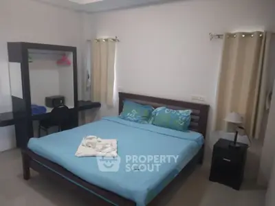 Cozy bedroom with modern furnishings and natural light