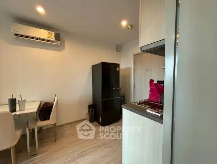 Modern apartment interior with dining area and kitchen appliances