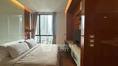 Modern bedroom with city view, featuring sleek design and natural light.