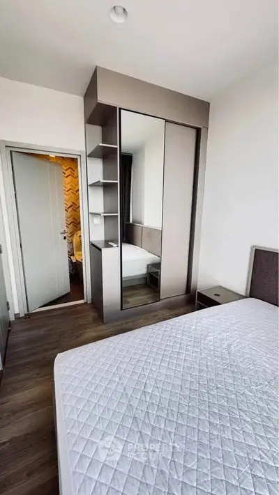 Modern bedroom with sleek wardrobe and comfortable bed in a stylish apartment.