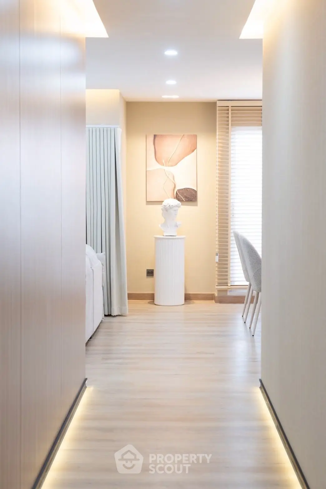 Elegant hallway with modern decor and soft lighting in a stylish apartment.
