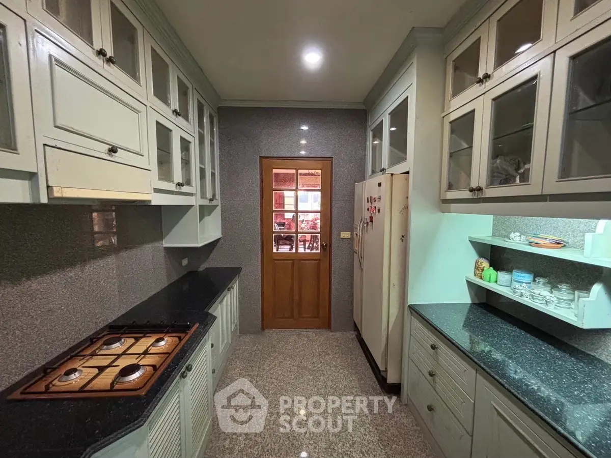 Charming kitchen with gas stove and ample storage in a cozy home setting.