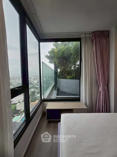 Modern bedroom with stunning city view and large windows