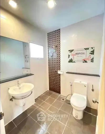 Modern bathroom with stylish tile design and sleek fixtures in a contemporary home.