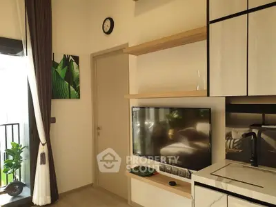 Modern living room with sleek TV setup and balcony view