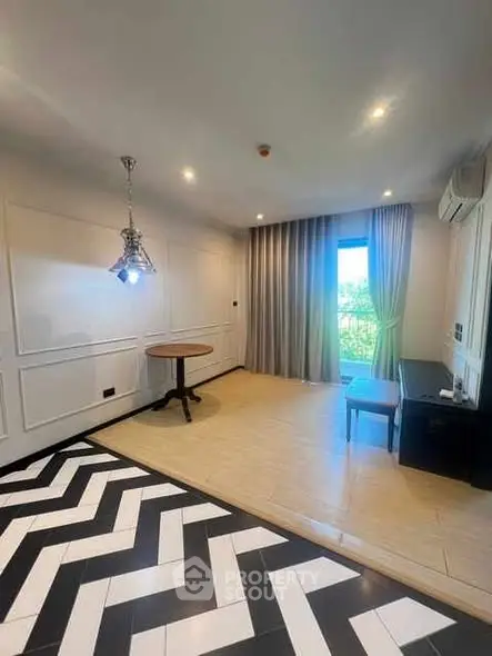 Stylish modern living room with unique flooring and elegant lighting.