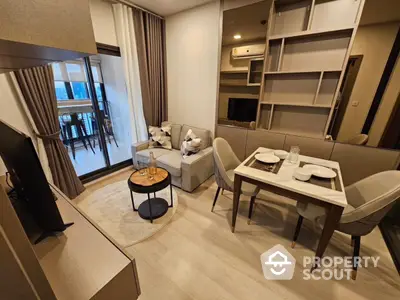 Modern living room with cozy seating and dining area, featuring stylish decor and balcony access.