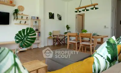 Charming living room with modern decor and natural light, featuring stylish furniture and lush greenery.