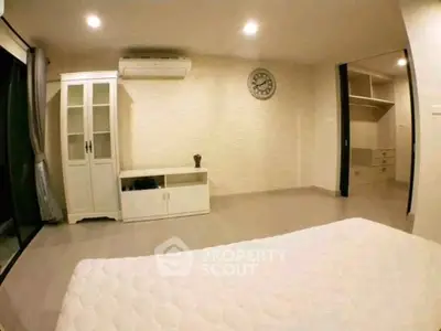 Spacious bedroom with modern decor and ample storage space