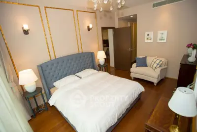 Luxurious bedroom with elegant decor, plush bed, and cozy seating area in a modern home.