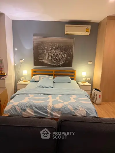 Cozy bedroom with modern decor and air conditioning, featuring a stylish bed and ambient lighting.