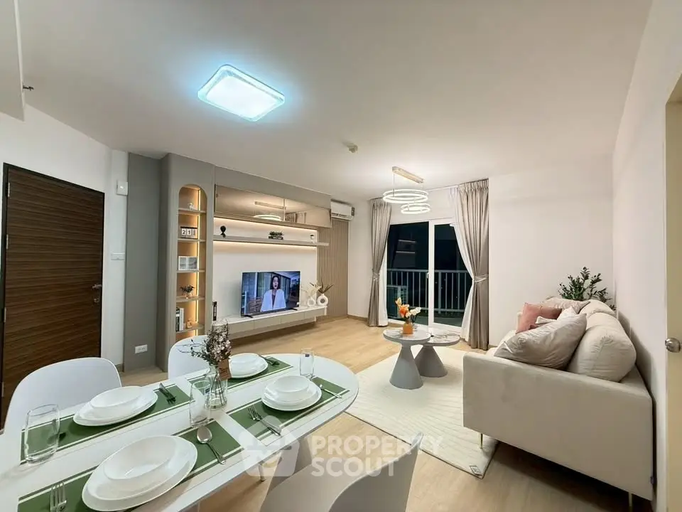 Modern living room with stylish decor and dining area, featuring elegant lighting and cozy ambiance.