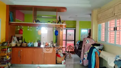 Vibrant living room with colorful decor and open kitchen layout