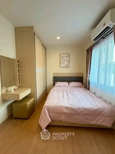Cozy bedroom with natural light, featuring a comfortable bed and stylish decor, perfect for relaxation.