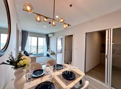 Elegant dining area with modern chandelier and stylish decor in a contemporary apartment.