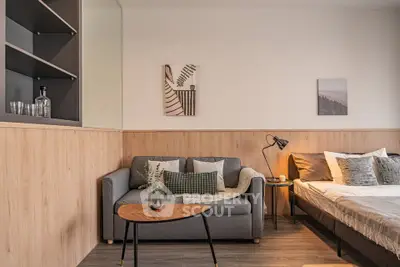 Modern studio apartment with cozy living area and stylish decor