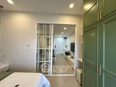 Modern bedroom with sliding glass doors and green wardrobe