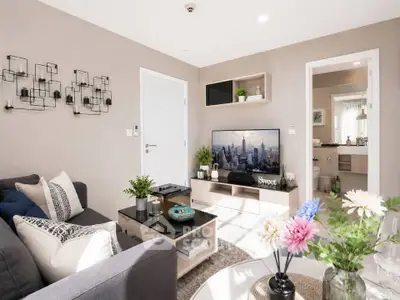 Stylish modern living room with cozy decor and open view to bathroom, perfect for urban living.