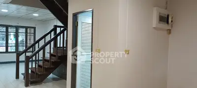 Spacious interior with wooden staircase and natural light, ideal for modern living.