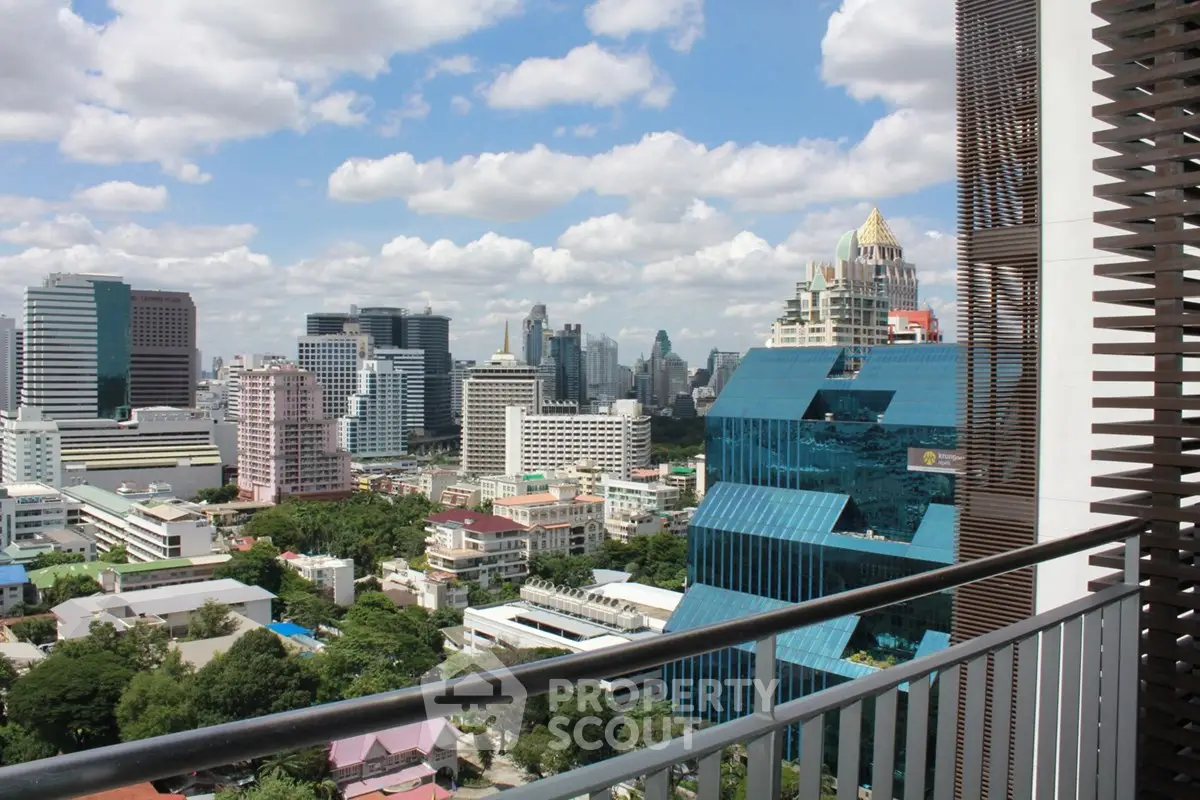 Stunning cityscape view from a modern balcony with iconic skyscrapers and lush greenery.