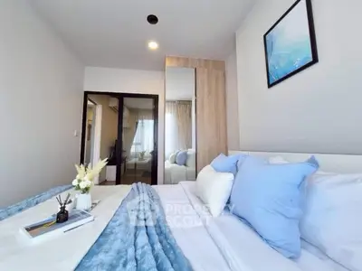 Modern bedroom with stylish decor and cozy bedding in a contemporary apartment.