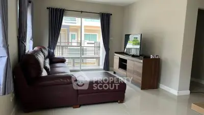 Modern living room with leather sofa and large window view