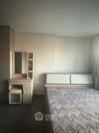 Spacious bedroom with modern decor and natural lighting