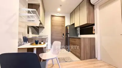 Modern kitchen with sleek cabinetry and dining area in a stylish apartment