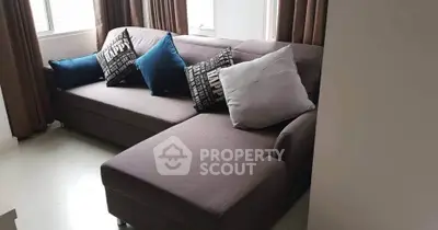 Stylish modern living room with cozy sectional sofa and decorative pillows, perfect for relaxation.