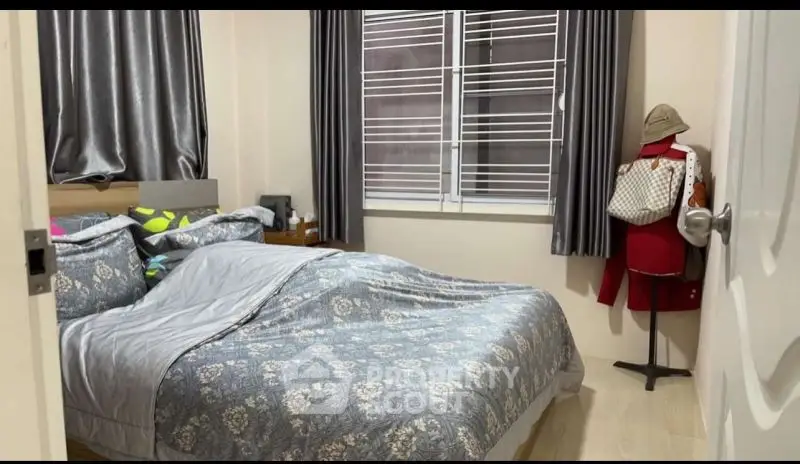 Cozy bedroom with stylish decor and ample natural light, perfect for relaxation and comfort.