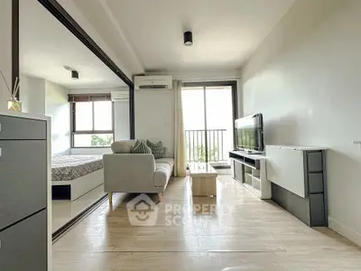 Modern living room with balcony and sleek furniture, bright and airy space.