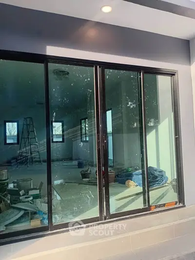 Modern sliding glass doors leading to a spacious unfinished interior, perfect for customization.