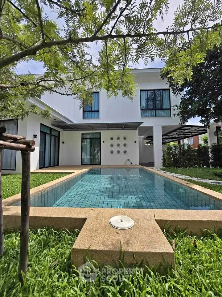 Luxurious modern home with private pool and lush garden, perfect for serene living.