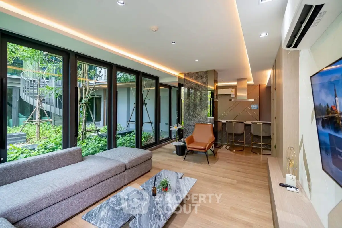 Luxurious modern living room with garden view, stylish furniture, and open layout in a contemporary home.