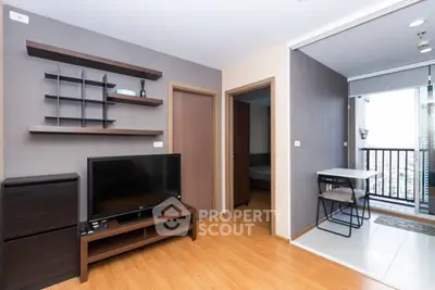 Modern living room with TV and balcony access in a stylish apartment.