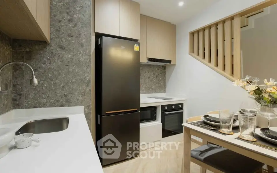 Modern kitchen with sleek appliances and elegant dining setup