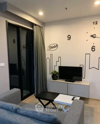 Modern living room with stylish wall clock and cozy seating area, perfect for relaxation.